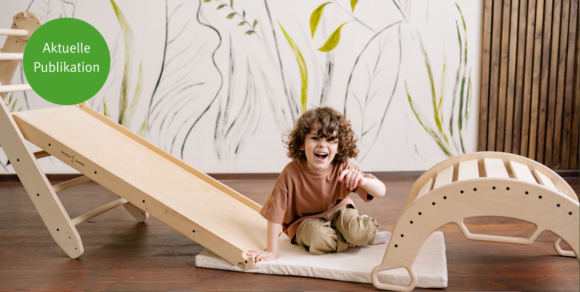 Junge in Kita sitzt an einer Holzrutsche